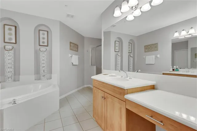 a bathroom with a sink a vanity a mirror and a bathtub