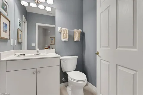 a bathroom with a sink and mirror with toilet