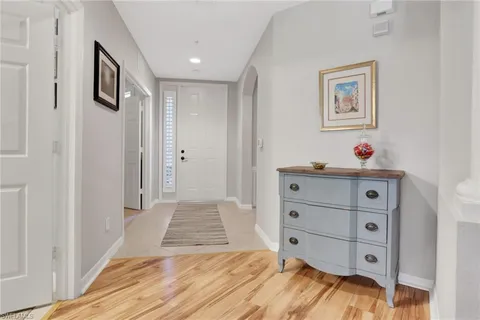 a view of a bedroom with baby bed and hallway