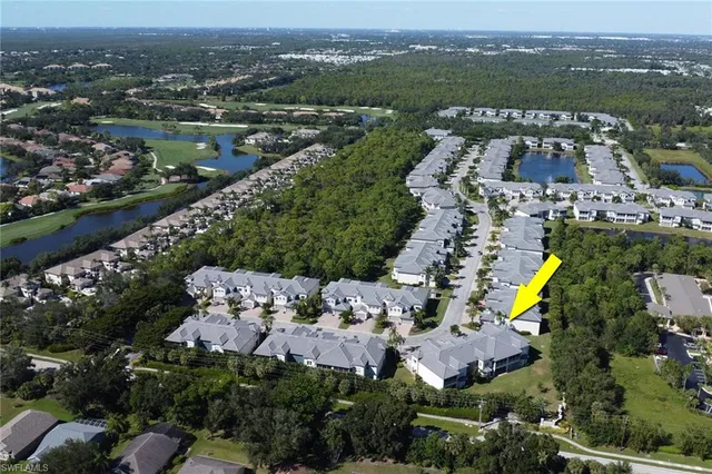 an aerial view of house with yard swimming pool and ocean view
