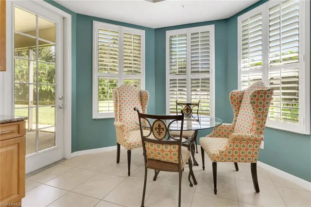 a view of a dining room with furniture and windows