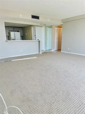 a view of a livingroom with an empty space and a window