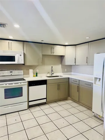 a kitchen with a sink cabinets and appliances