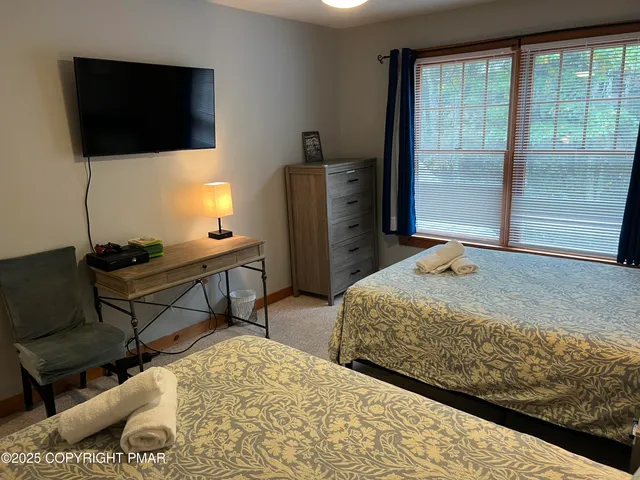 a bedroom with a bed and a television