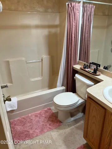 a bathroom with a shower and a wooden floor