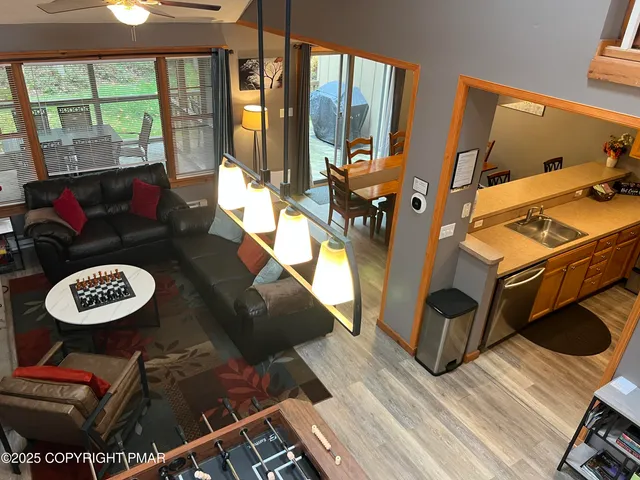 a living room with furniture and a floor to ceiling window