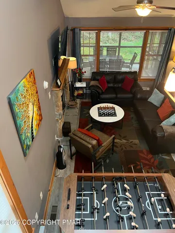 a living room with furniture and a floor to ceiling window