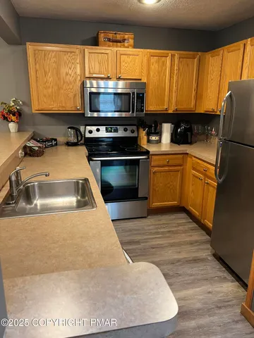 a kitchen with wooden cabinets a sink and a stove
