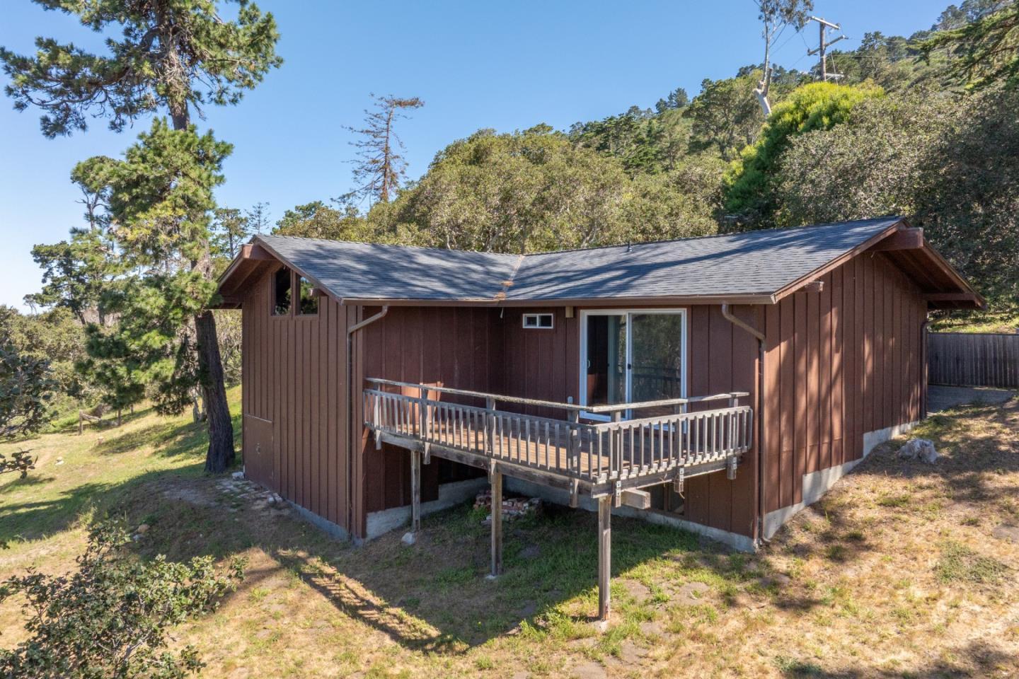 214 Crest Road Carmel, CA 93923 - Photo 21 of 29 a view of a house with a wooden deck front door