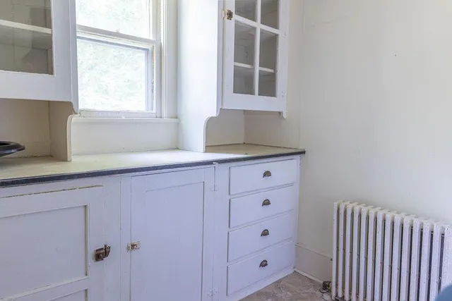a kitchen with cabinets appliances and a window
