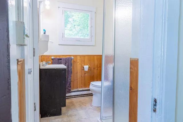 a bathroom with a shower and a toilet