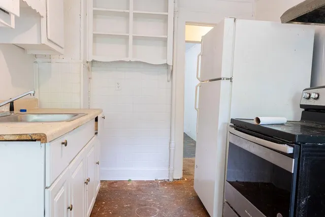 a kitchen with stainless steel appliances cabinets and a counter top space