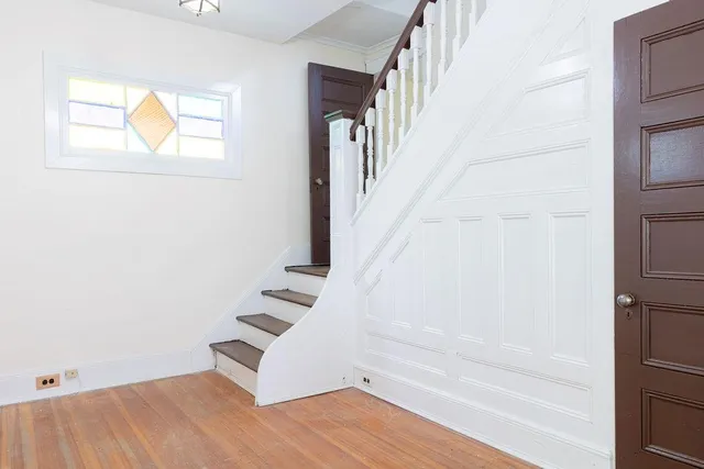 a view of an entryway with wooden floor