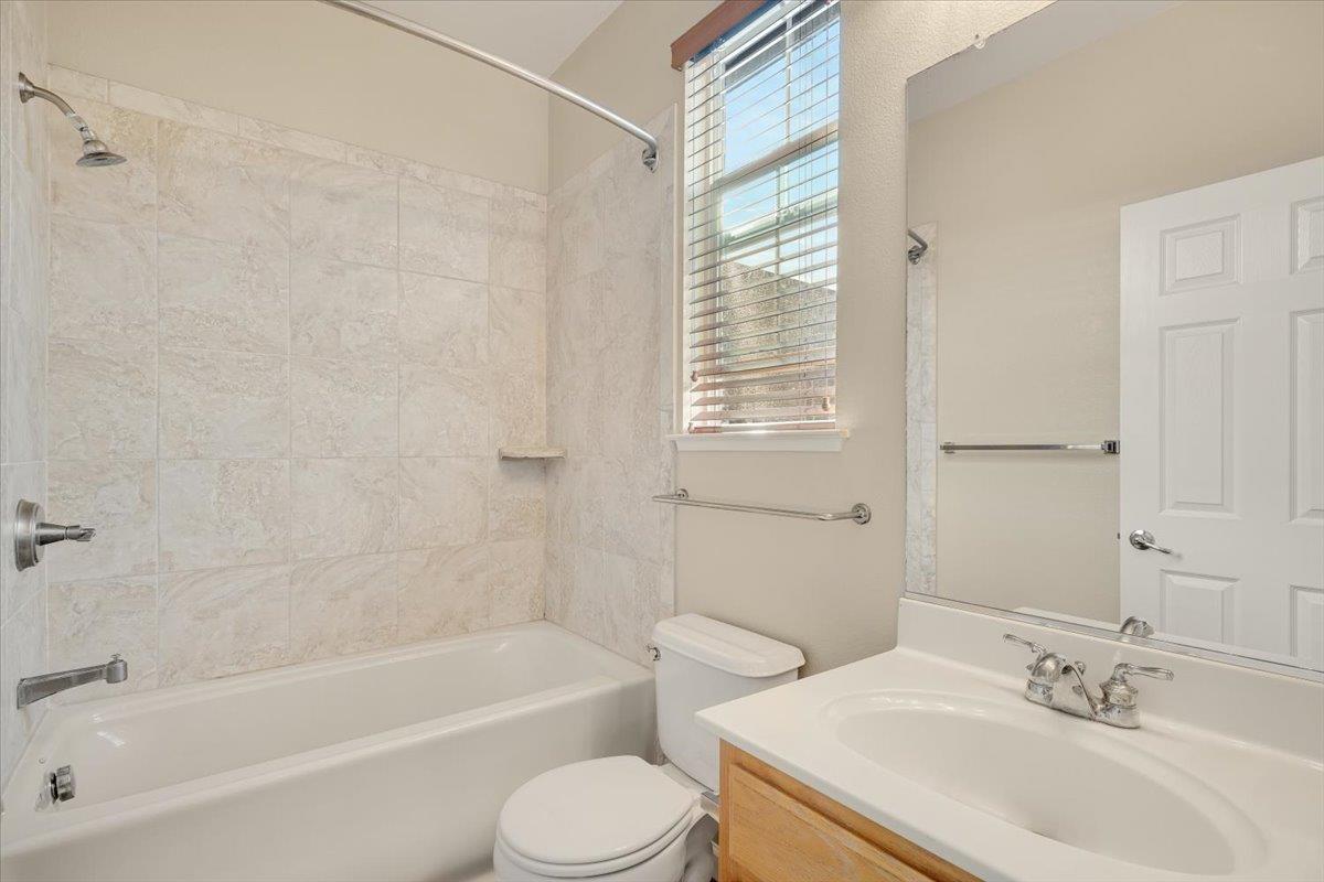 7835 Dickens Way Gilroy, CA 95020 - Photo 13 of 16 a bathroom with a bathtub shower sink vanity mirror and toilet