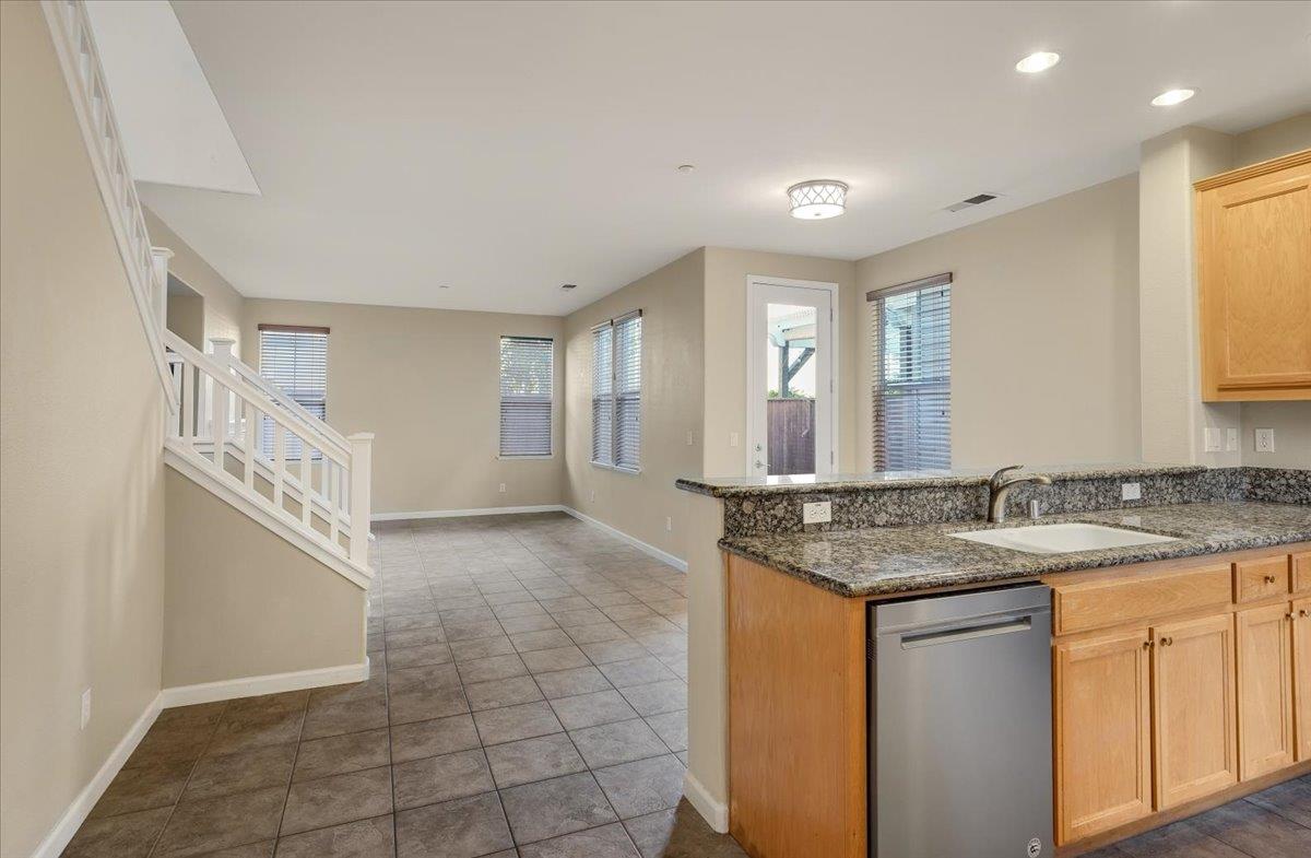 7835 Dickens Way Gilroy, CA 95020 - Photo 2 of 16 a bathroom with a granite countertop sink a mirror and a bathtub