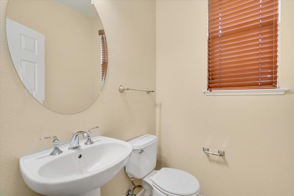 7835 Dickens Way Gilroy, CA 95020 - Photo 8 of 16 a bathroom with a sink a mirror and a toilet