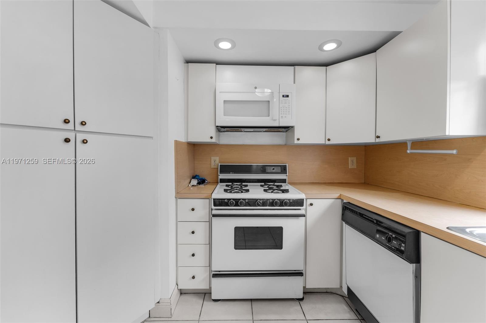 10915 Southwest 71st Street Miami, FL 33173 - Photo 11 of 33 a kitchen with cabinets appliances and a sink