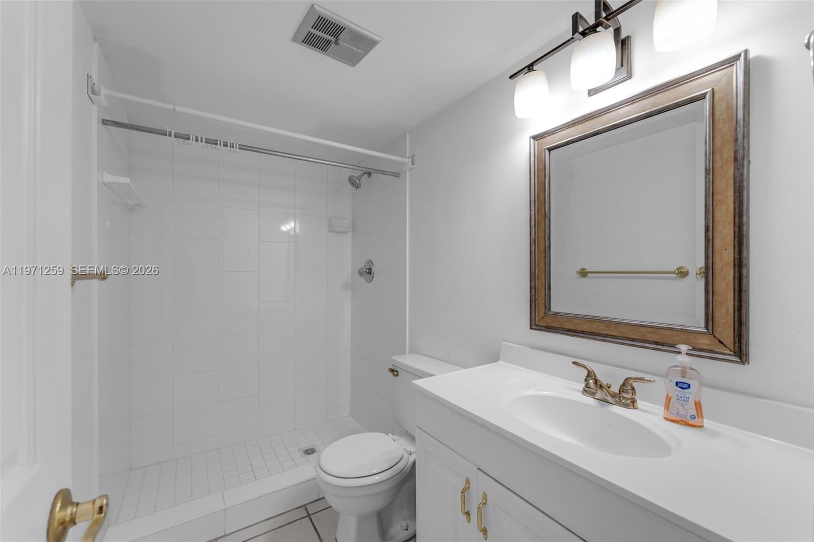 10915 Southwest 71st Street Miami, FL 33173 - Photo 15 of 33 a bathroom with a sink a toilet and shower