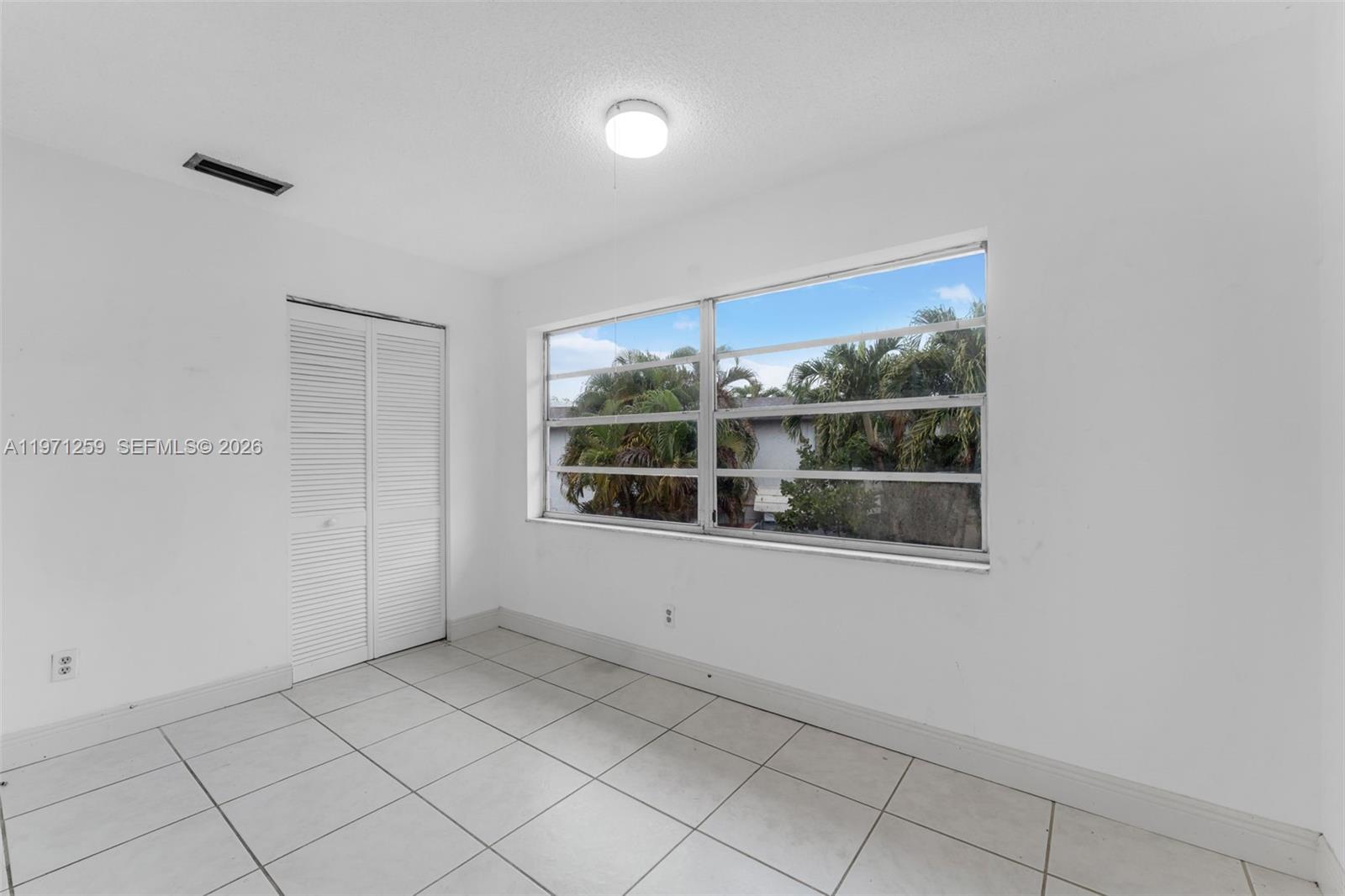 10915 Southwest 71st Street Miami, FL 33173 - Photo 17 of 33 an empty room with a window