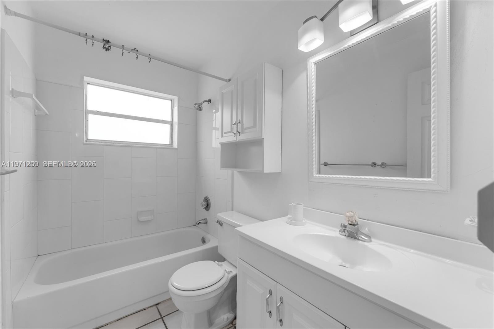 10915 Southwest 71st Street Miami, FL 33173 - Photo 18 of 33 a bathroom with a sink a toilet and a bathtub