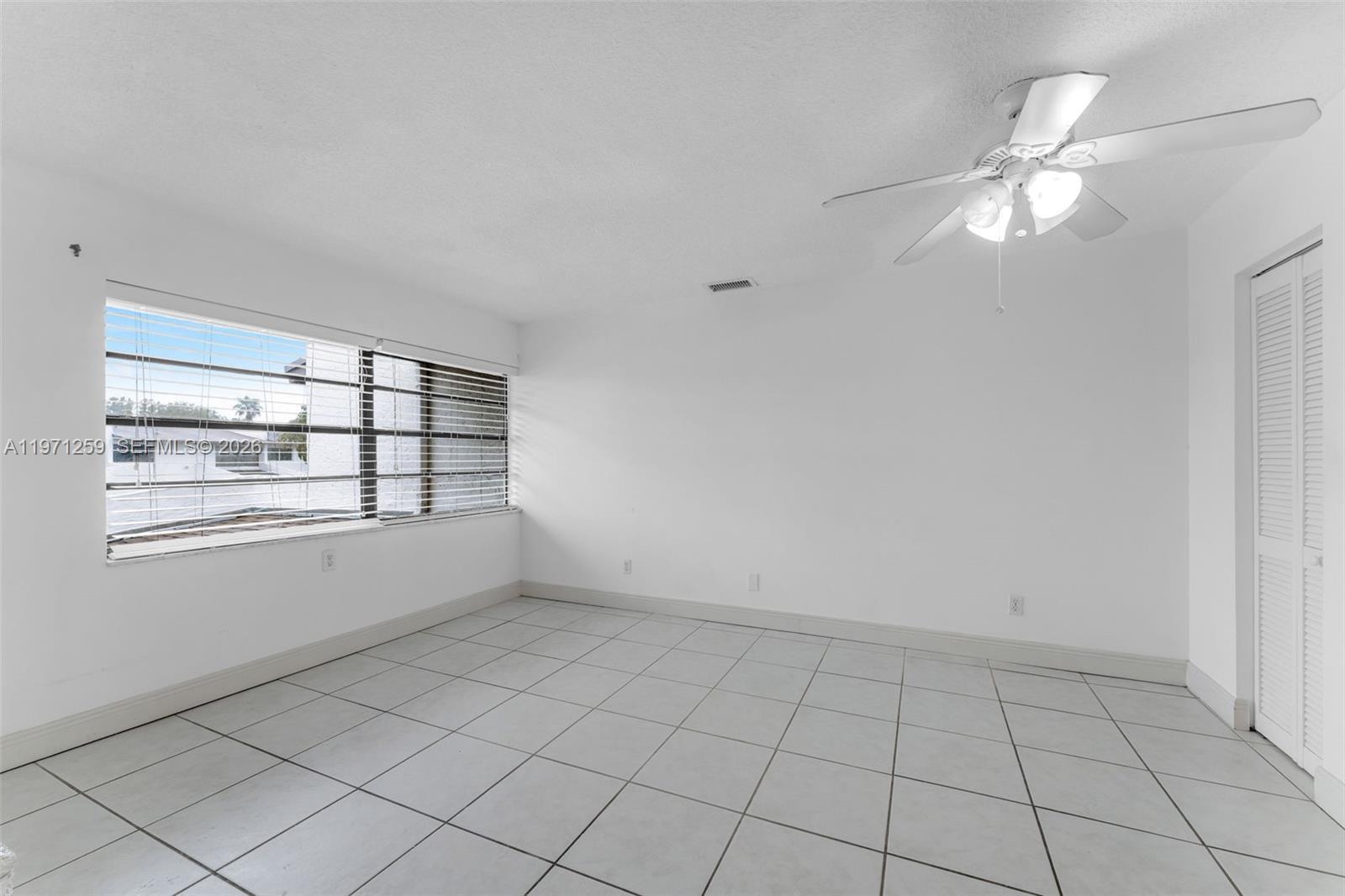 10915 Southwest 71st Street Miami, FL 33173 - Photo 19 of 33 a view of an empty room with a window