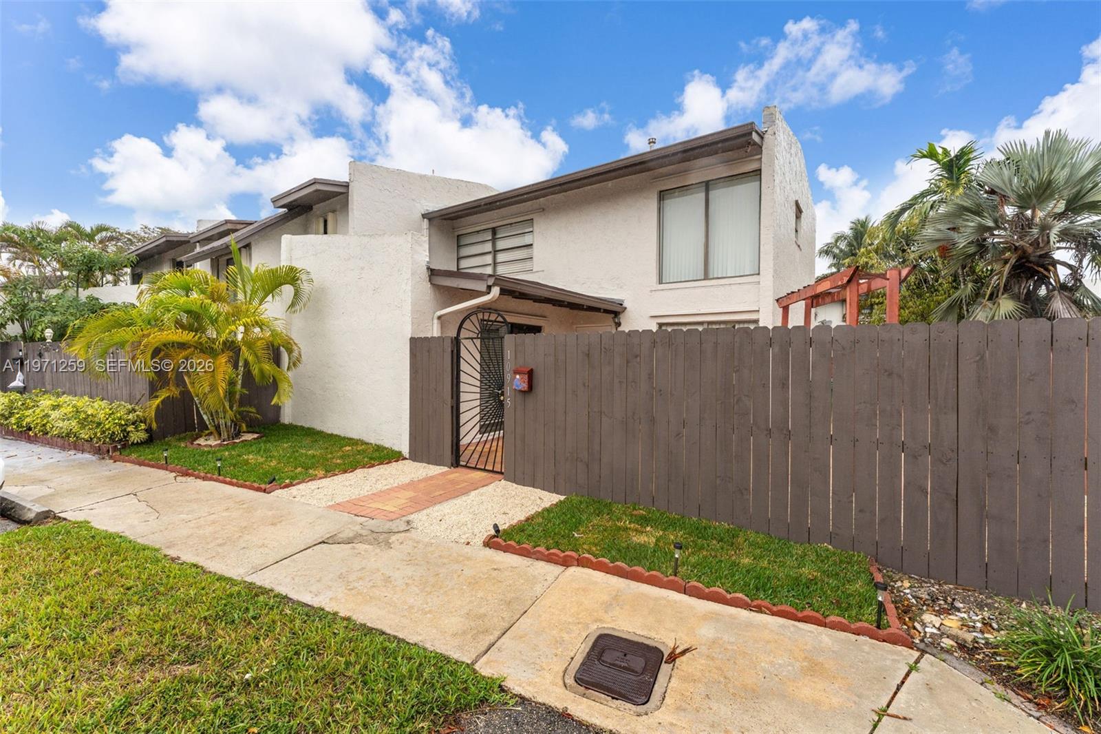 10915 Southwest 71st Street Miami, FL 33173 - Photo 2 of 33 a front view of a house with garden