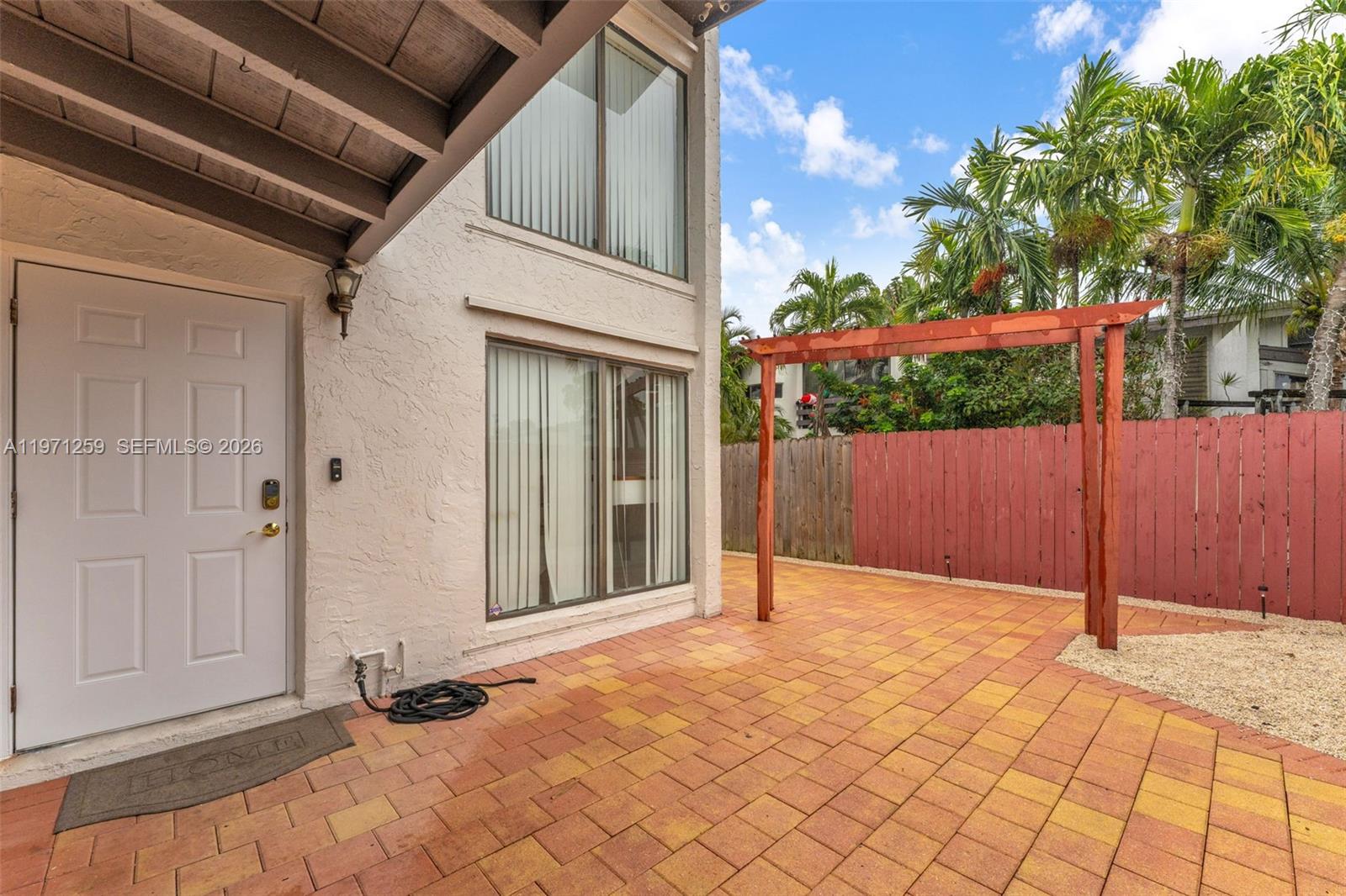 10915 Southwest 71st Street Miami, FL 33173 - Photo 25 of 33 a view of backyard with small cabin and wooden fence