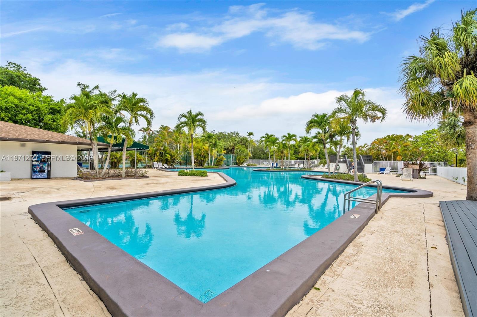 10915 Southwest 71st Street Miami, FL 33173 - Photo 30 of 33 a view of swimming pool with a table and chairs