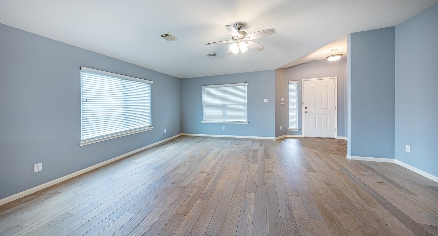 22715 Imperial Ivy Court Spring, TX 77373 - Photo 11 of 45 a view of an empty room with a window and wooden floor