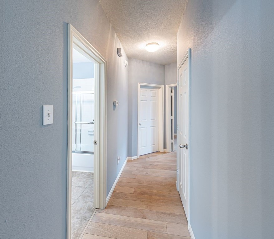 22715 Imperial Ivy Court Spring, TX 77373 - Photo 16 of 45 a view of a hallway with wooden floor and a bathroom