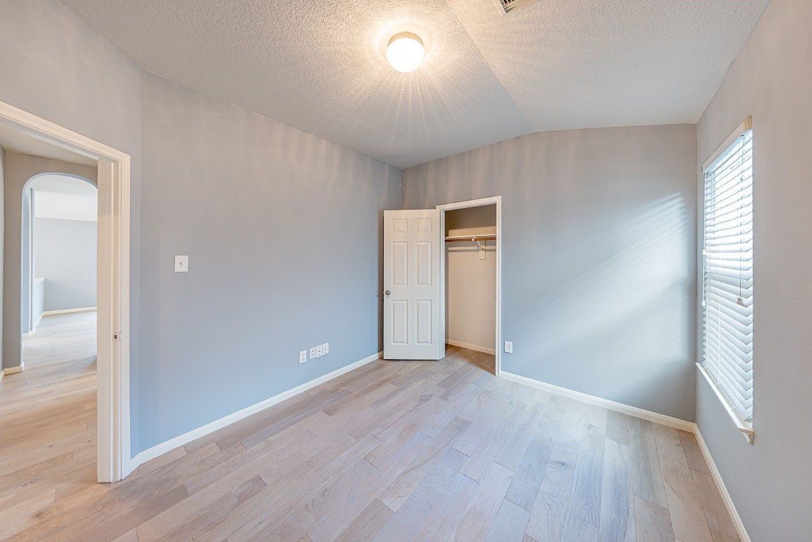 22715 Imperial Ivy Court Spring, TX 77373 - Photo 19 of 45 wooden floor in an empty room with a window