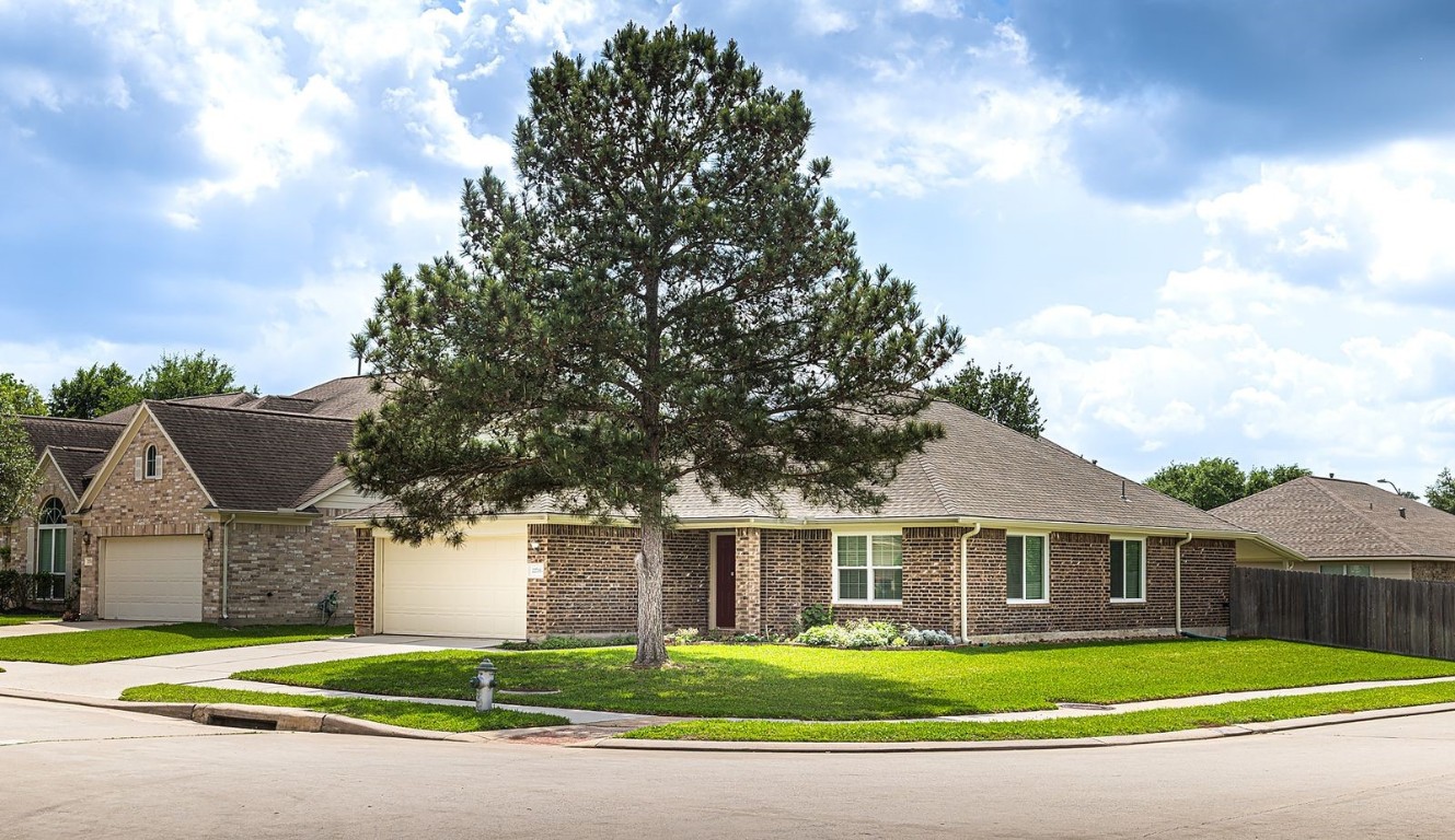 22715 Imperial Ivy Court Spring, TX 77373 - Photo 2 of 45 a front view of a house with a yard and garage