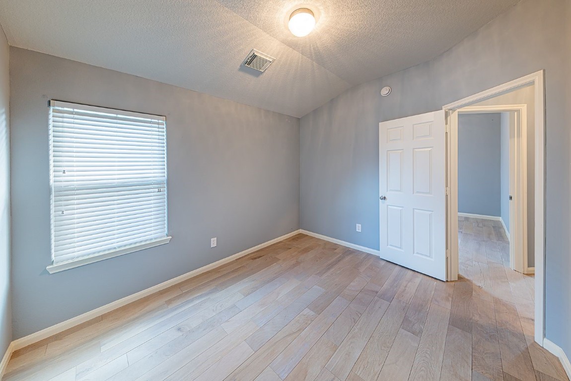 22715 Imperial Ivy Court Spring, TX 77373 - Photo 21 of 45 an empty room with wooden floor and windows