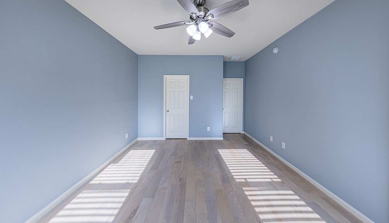 22715 Imperial Ivy Court Spring, TX 77373 - Photo 25 of 45 a view of wooden floor and chandelier fan in a room