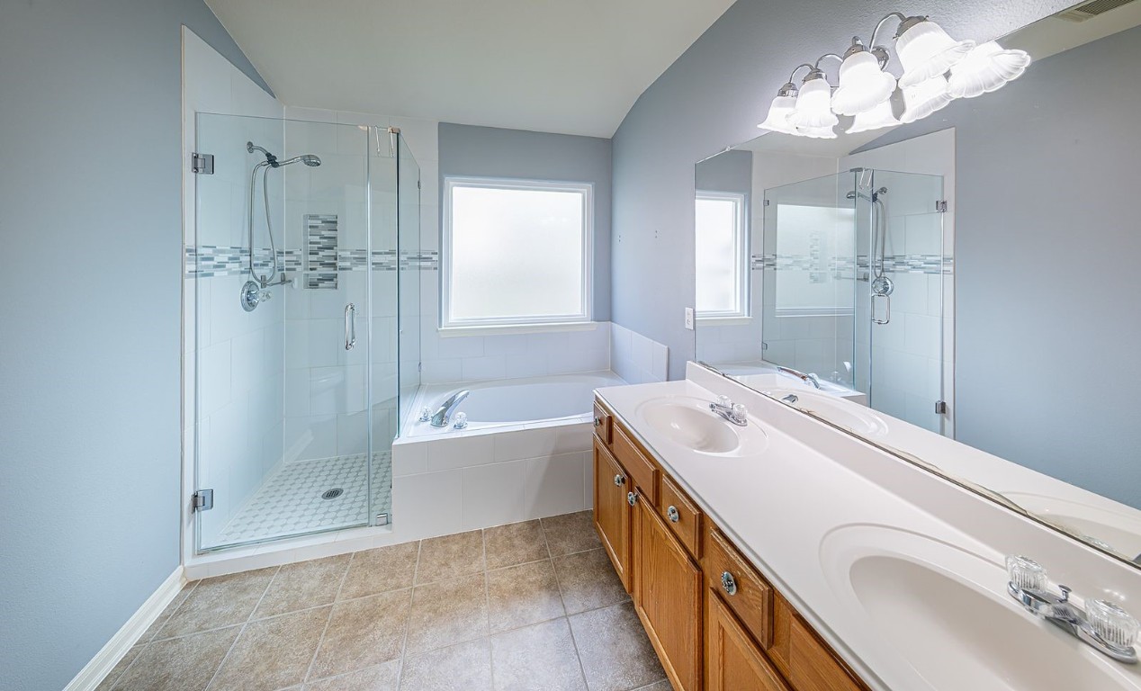 22715 Imperial Ivy Court Spring, TX 77373 - Photo 27 of 45 a bathroom with a sink a large mirror and shower