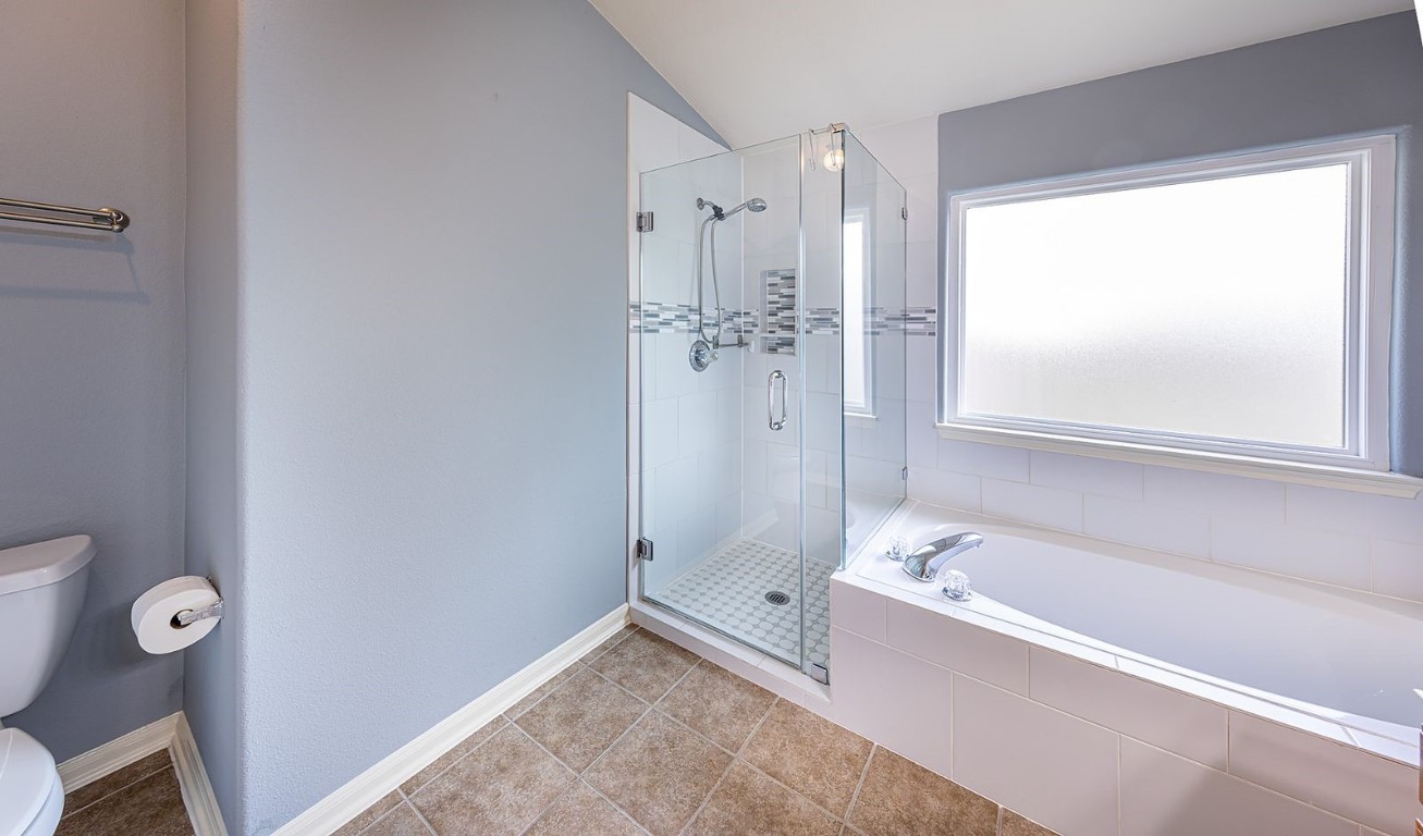 22715 Imperial Ivy Court Spring, TX 77373 - Photo 28 of 45 a bathroom with a bathtub shower and a toilet
