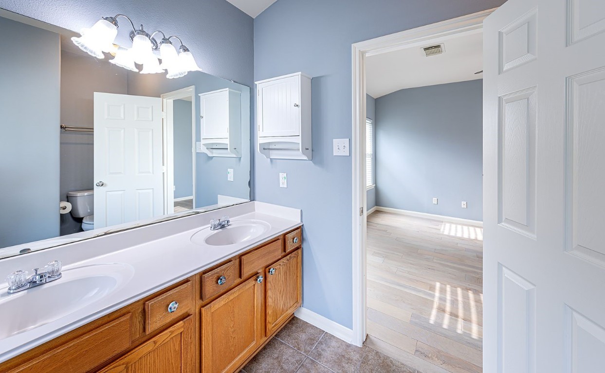 22715 Imperial Ivy Court Spring, TX 77373 - Photo 29 of 45 a bathroom with a double vanity sink and a mirror