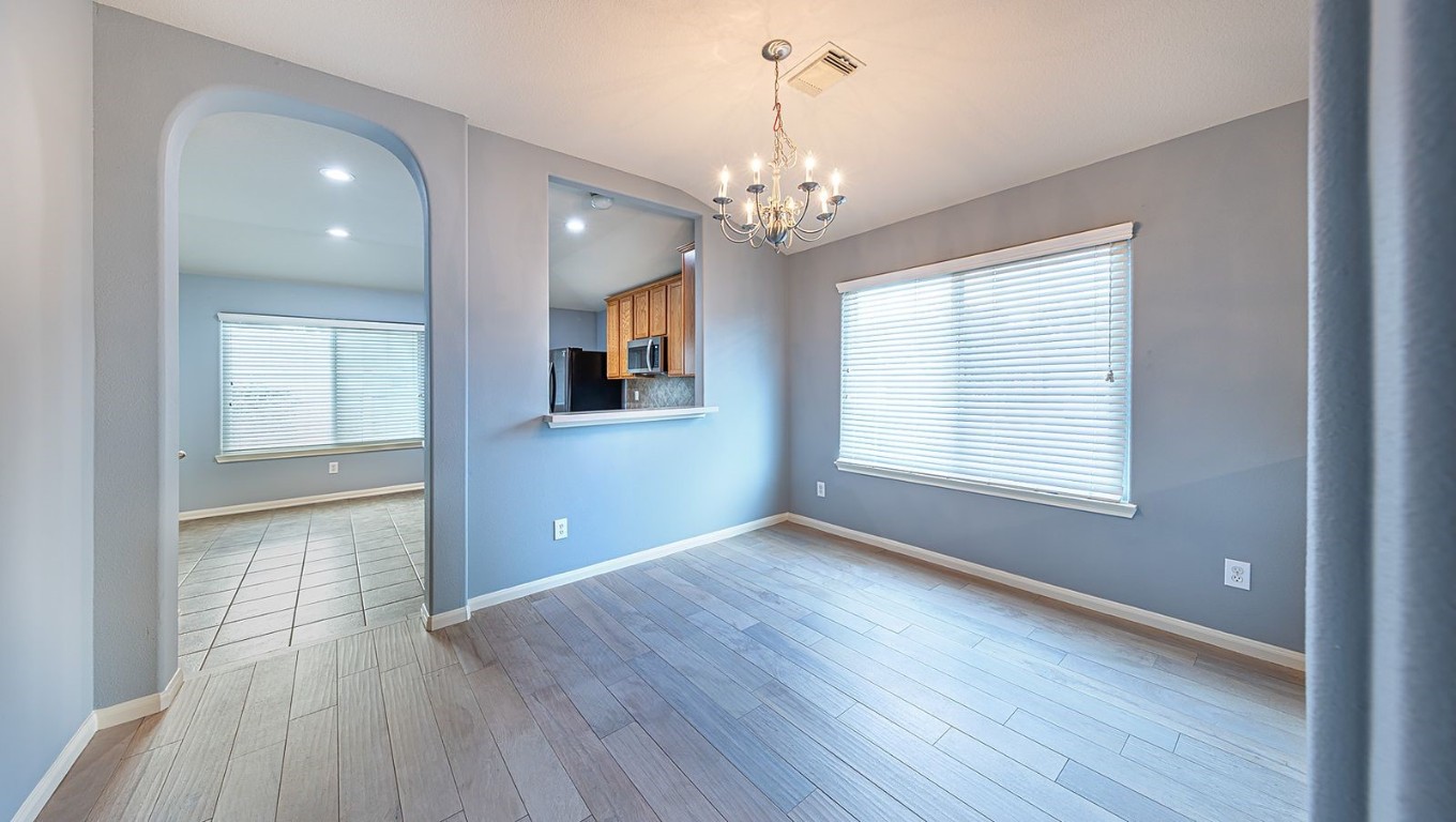22715 Imperial Ivy Court Spring, TX 77373 - Photo 31 of 45 a view of an empty room with wooden floor and a window