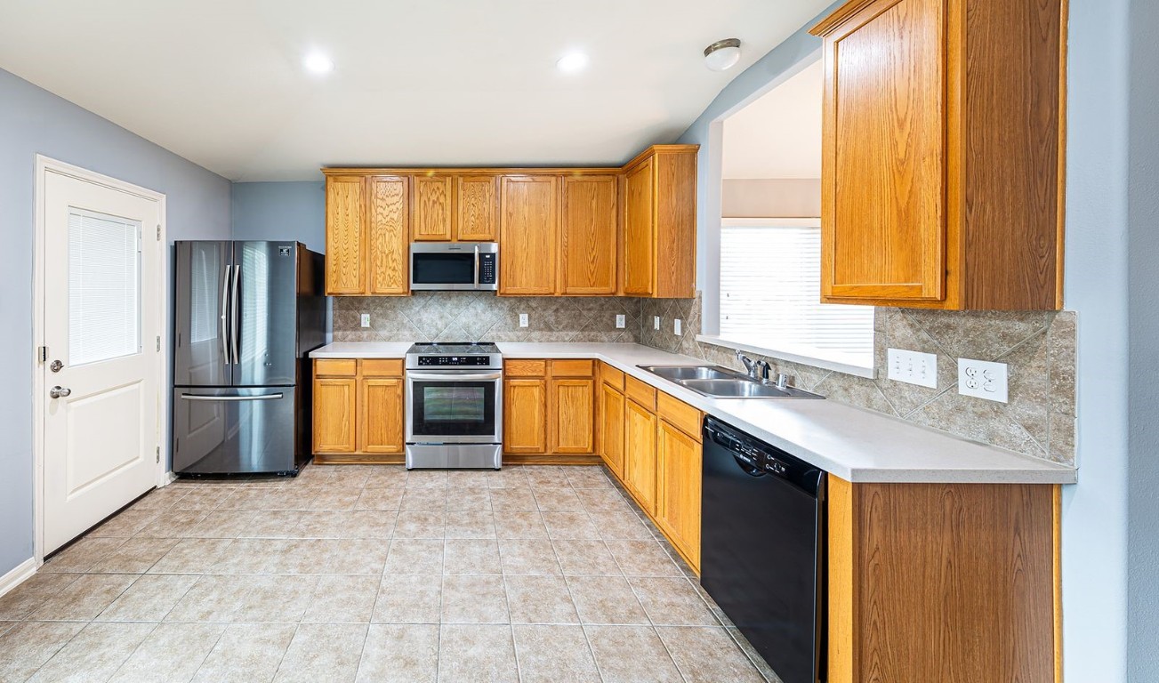 22715 Imperial Ivy Court Spring, TX 77373 - Photo 36 of 45 a kitchen with a sink a refrigerator and a sink