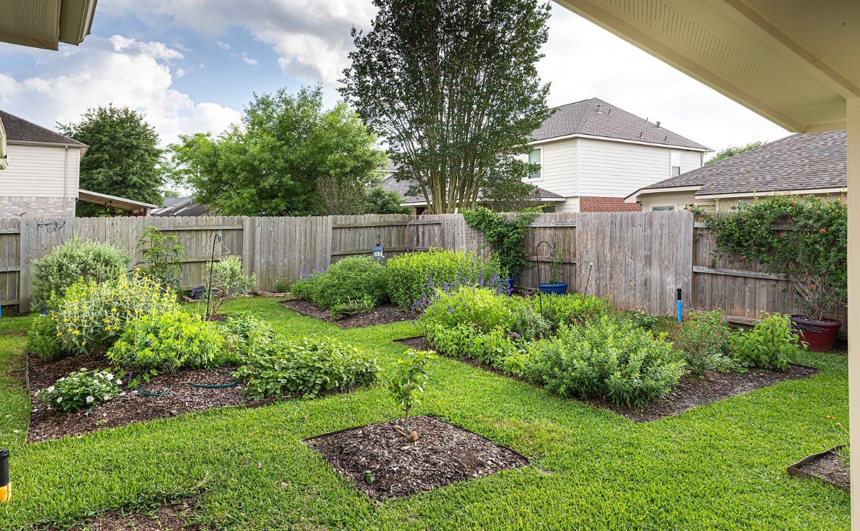 22715 Imperial Ivy Court Spring, TX 77373 - Photo 39 of 45 a view of a backyard with plants and a garden