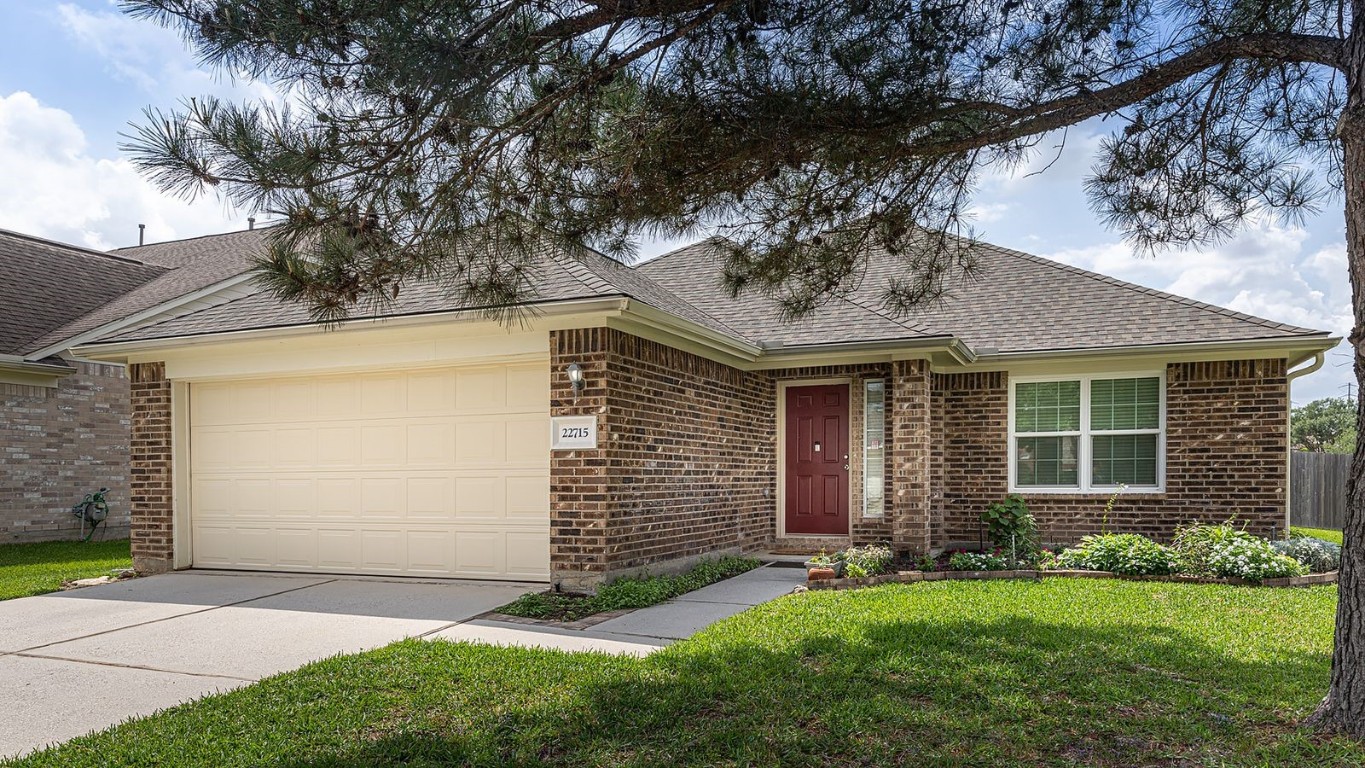 22715 Imperial Ivy Court Spring, TX 77373 - Photo 4 of 45 a view of a house with brick walls and a yard with plants