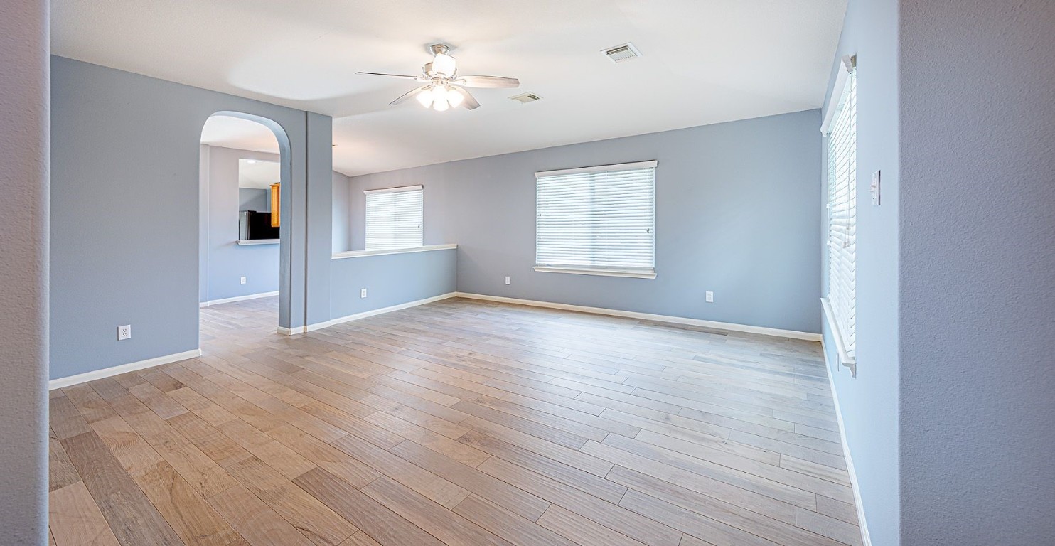 22715 Imperial Ivy Court Spring, TX 77373 - Photo 9 of 45 a view of an empty room with window and wooden floor