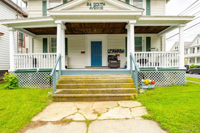 a front view of a house with a garden