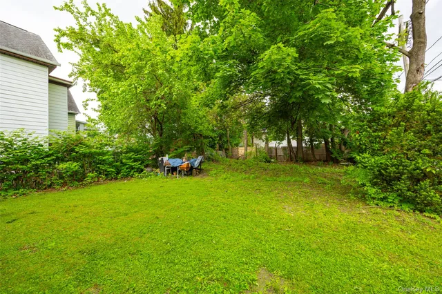 a view of green field with trees in the background