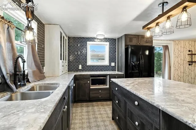 a kitchen with granite countertop a sink stove and cabinets