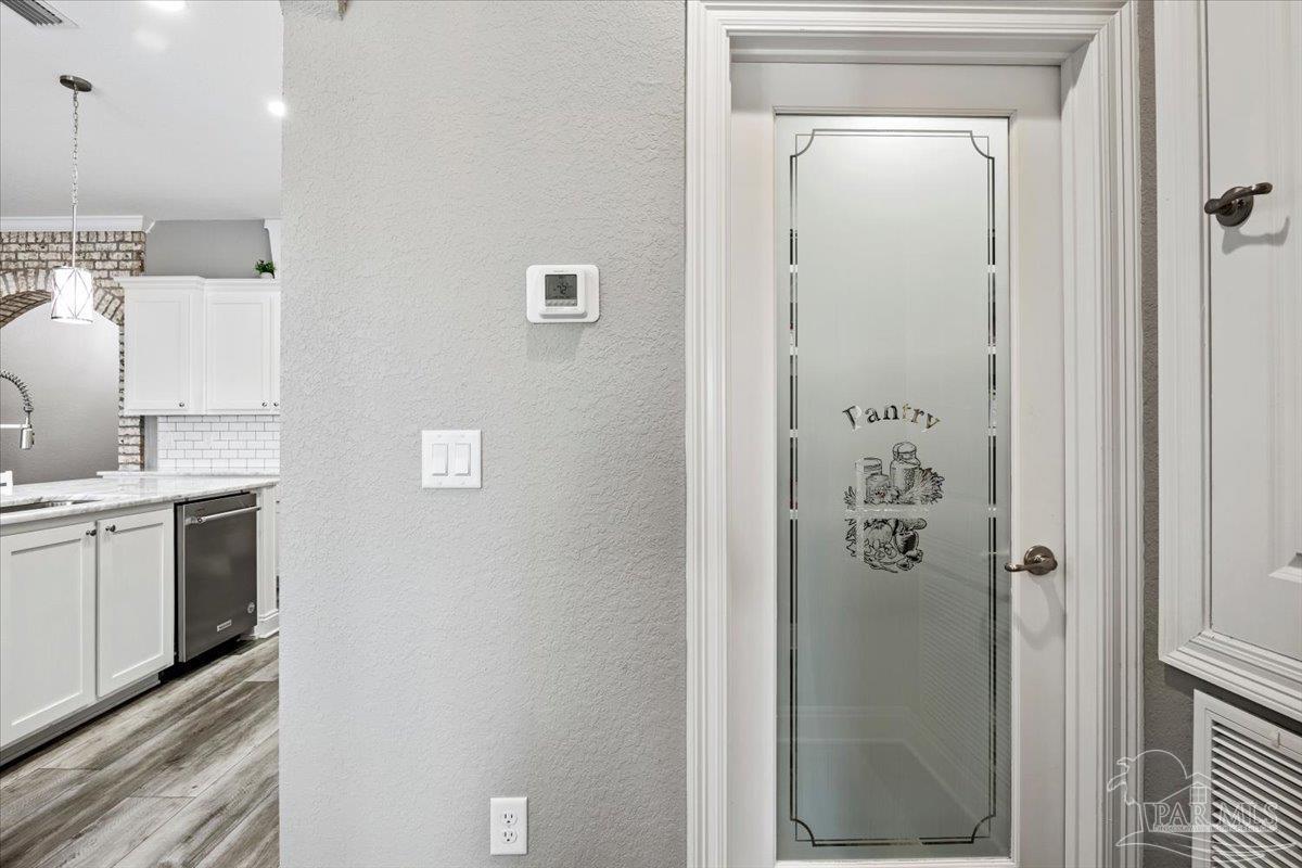9258 Roy Cook Road Pace, FL 32571 - Photo 26 of 63 a bathroom with a granite countertop sink a mirror and shower