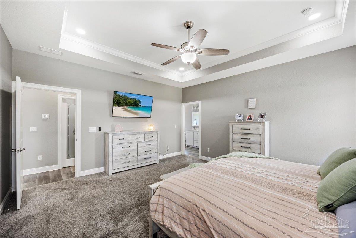 9258 Roy Cook Road Pace, FL 32571 - Photo 31 of 63 a bedroom with a large bed and a ceiling fan