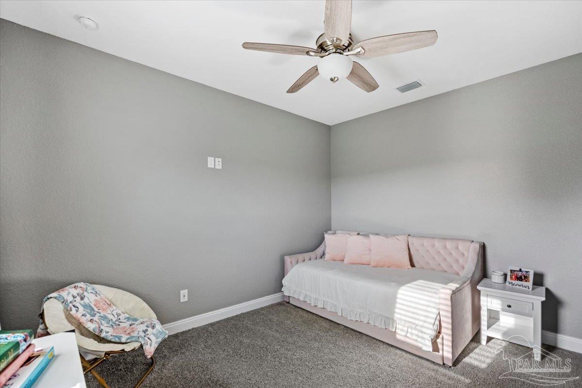 9258 Roy Cook Road Pace, FL 32571 - Photo 44 of 63 a room with a bed and a chandelier