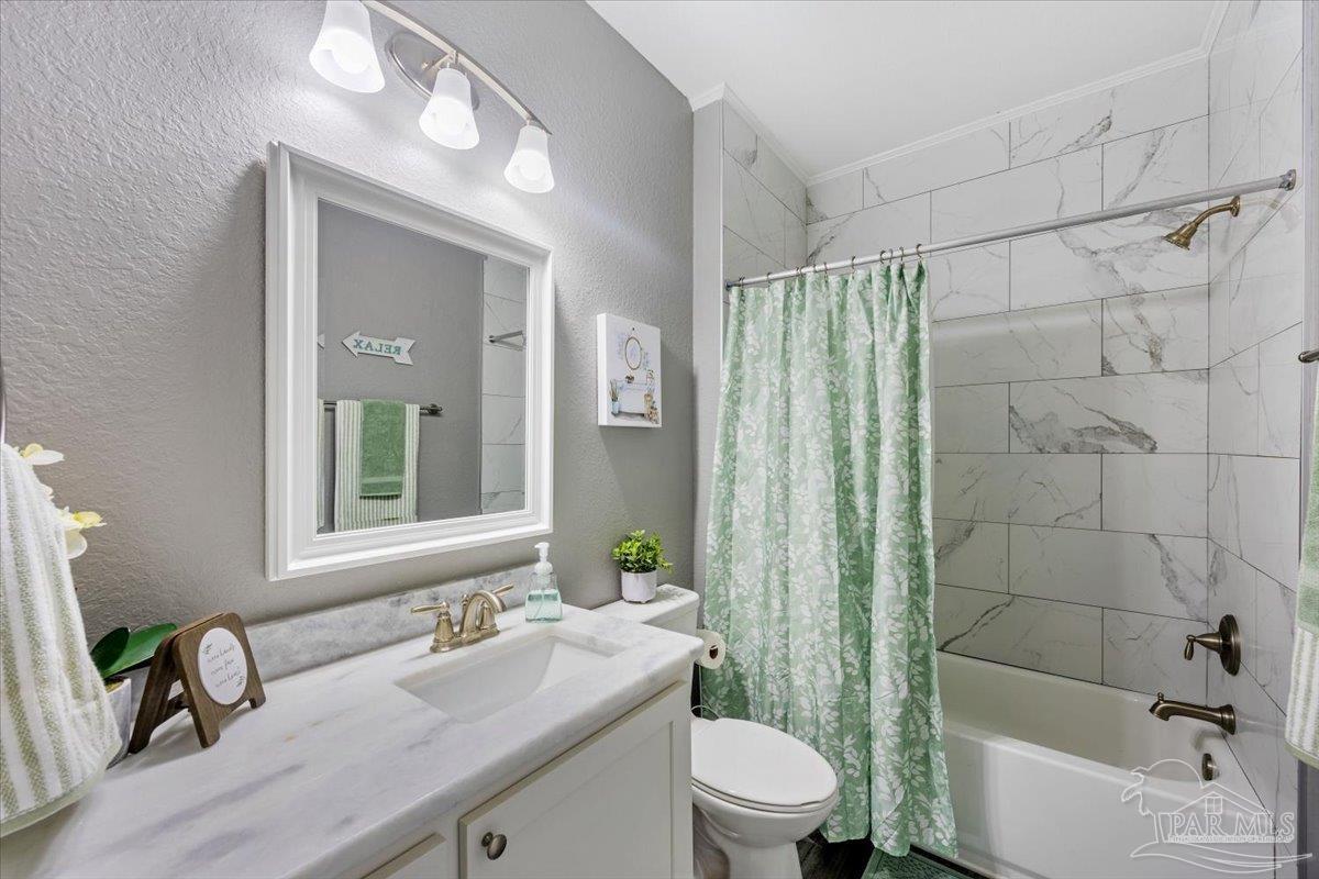 9258 Roy Cook Road Pace, FL 32571 - Photo 45 of 63 a bathroom with a sink a toilet and shower