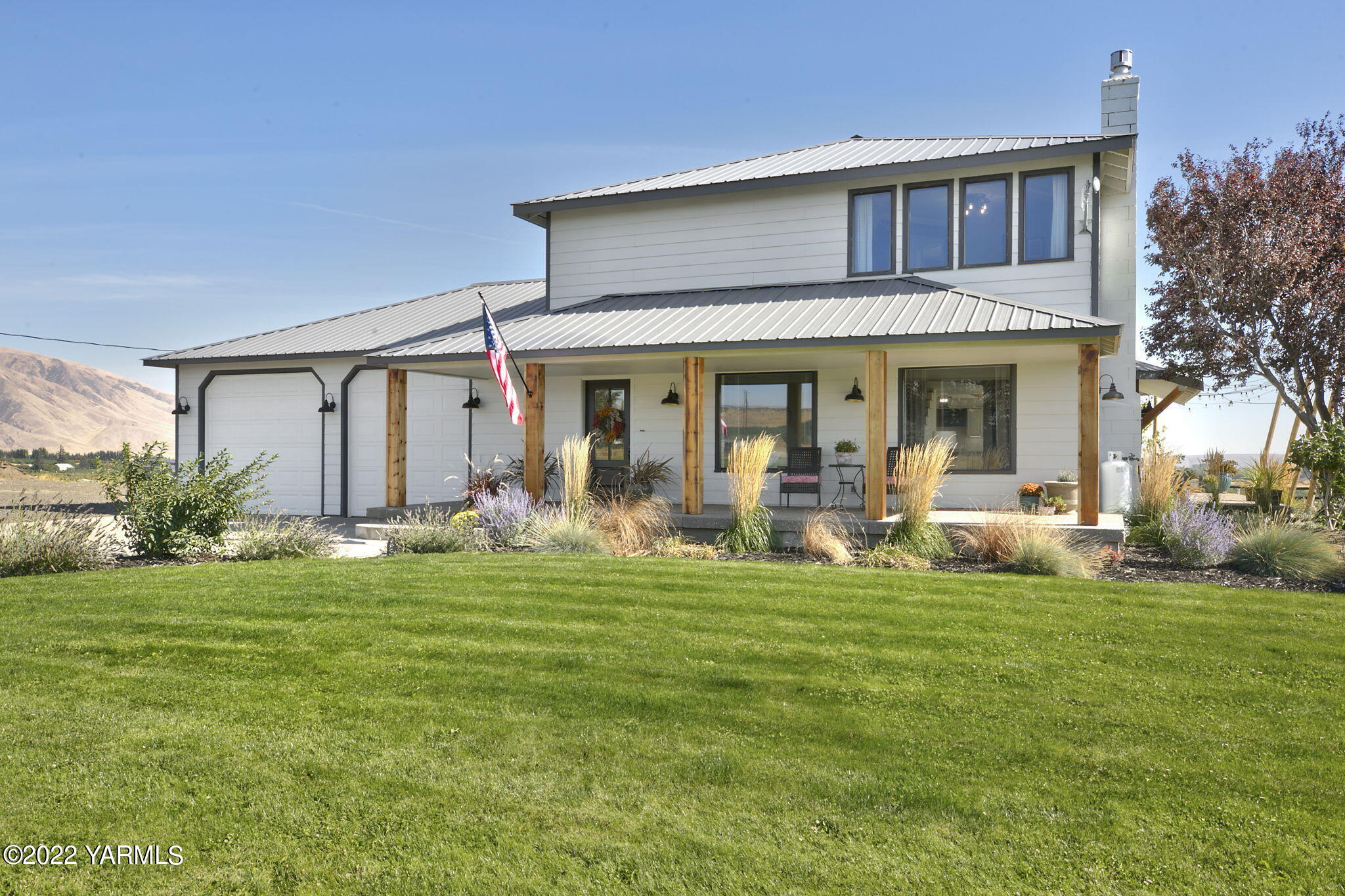 341 Section 1 Road Tieton, WA 98947 - Photo 30 of 44 a front view of a house with a garden and plants